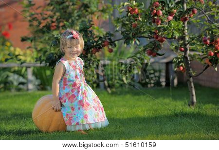 Smiling Girl On Pumpking Over Apple Tree On A Farm