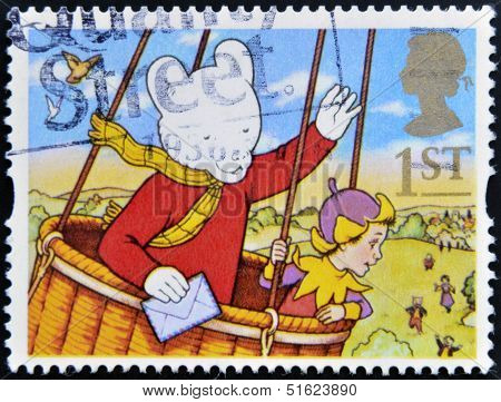 A stamp printed in Great Britain shows Rupert Bear in hot air balloon