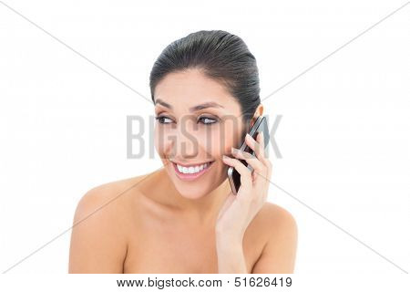 Attractive brunette making a call on smartphone on white background