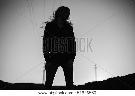 Silhouette of stylish woman at night time