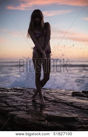 Shadow of attractive woman on sea background at dusk