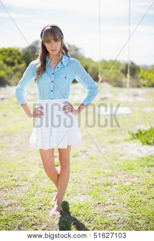 Trendy young model posing  while walking in a garden