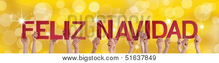 Hands Holding Feliz Navidad With Golden Background