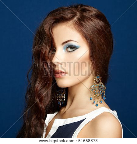 Portrait Of Beautiful Brunette Woman With Earring. Perfect Makeup
