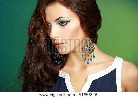 Portrait Of Beautiful Brunette Woman With Earring. Perfect Makeup