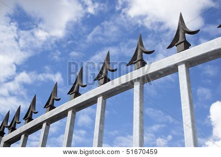 Angled Closeup View Of Galvanised Security Gate And Decorative Spikes