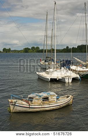 Abandoned Wooden Boat Moored In A Port River
