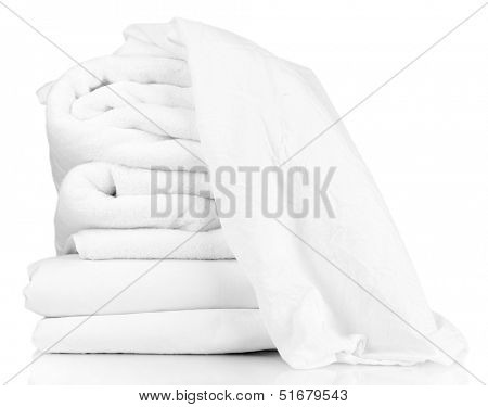 Stack of rumpled bedding sheets isolated on white