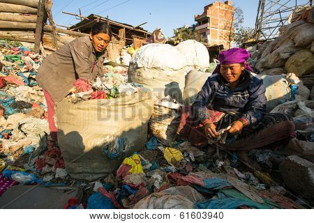KATHMANDU, NEPAL - DEC 22, 2013: Unidentified people from poorer areas working in sorting of plastic on the dump. Only 35% of population have access to adequate sanitation.
