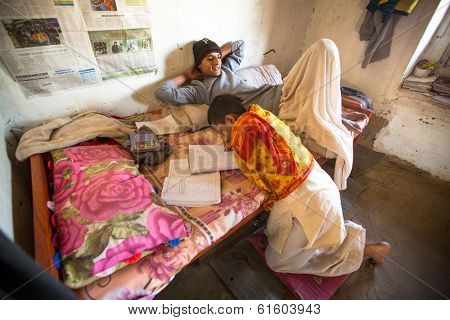 KATHMANDU, NEPAL - DEC 9, 2013: Unknown children doing homework at Jagadguru School. School established at 2013, to let new generation learn Sanskrit and preserve Hindu culture.
