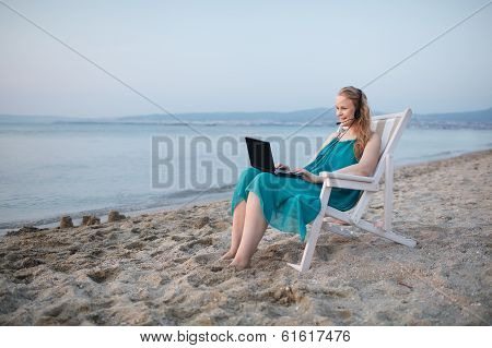 Woman talking skype at the beach