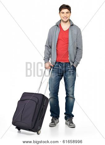 Full portrait of smiling happy man with grey suitcase - isolated on white