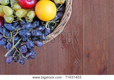 Fresh Fruit In The Basket On The Wooden Table
