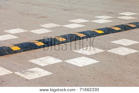 Traffic Safety Speed Bump On An Asphalt Road