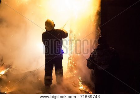 Firefighters extinguishing fire in building