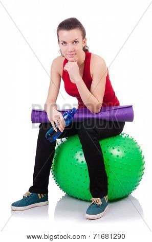 Young woman exercising with swiss ball