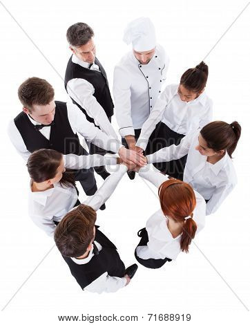 Waiters And Waitresses Stacking Hands