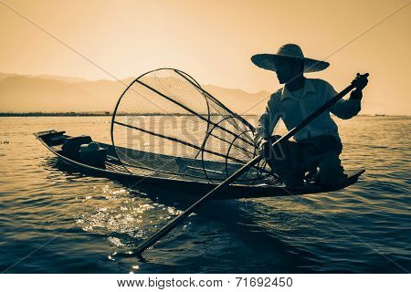 Myanmar travel attraction landmark - Traditional Burmese fisherman at Inle lake, Myanmar famous for their distinctive one legged rowing style