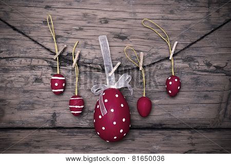 Many Red Easter Eggs And One Big Egg Hanging On Line Frame
