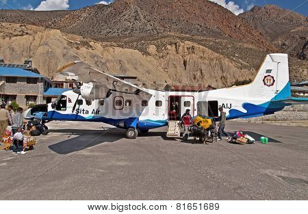 Passengers Arrived And Unloaded Luggage From The Plane Of Sita Air