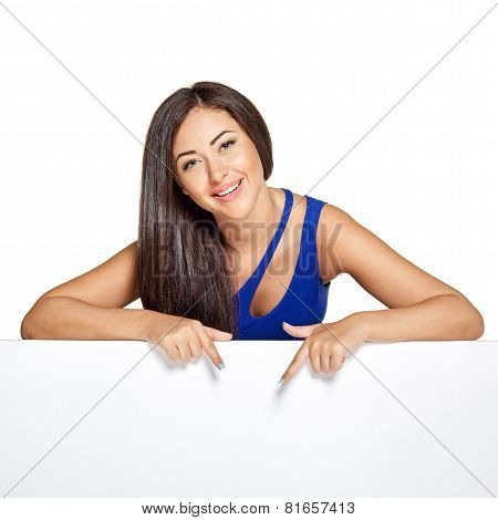 Young pretty woman peeking out from behind the wall