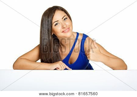 Young pretty woman peeking out from behind the wall