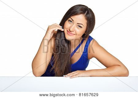 Young pretty woman peeking out from behind the wall