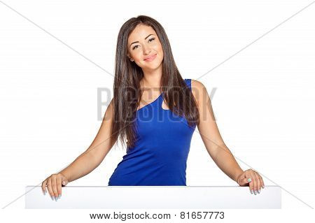 Young pretty woman peeking out from behind the wall