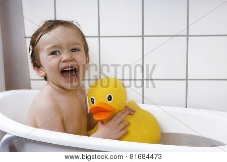 Cute Toddler Playing In A Bathtub