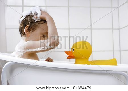 Cute Toddler Playing In A Bathtub