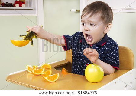 Small Boy Playing With His Fruit