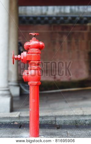 Red Fireplug Standing On Footpath