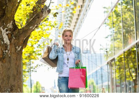 Girl walking down the street with shopping bags