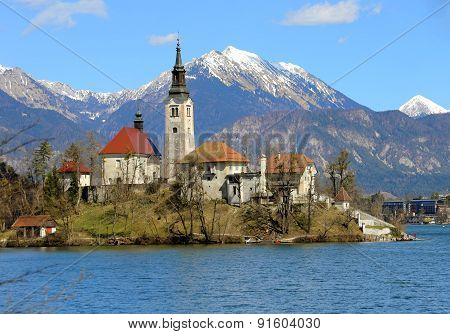 Church On The Island Of Lake Bled In Slovenia And The Snowy Mountains