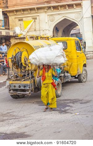 Indian Woman Carries Heavy Load On Her Head