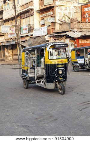 Auto Rickshaw Taxi Driver With Passengers In Operation