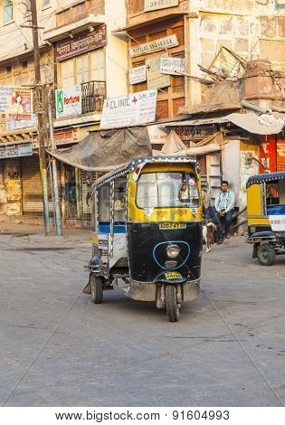 Auto Rickshaw Taxi Driver With Passengers In Operation