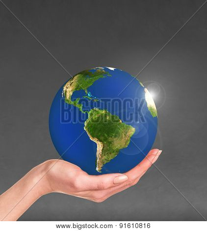 Planet earth in a human hand