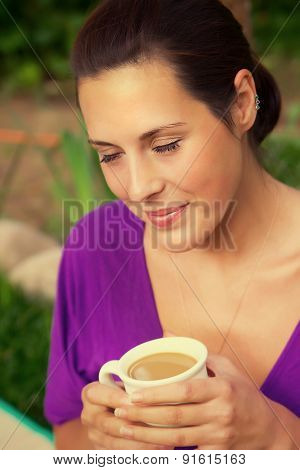 Beautiful Young Woman Drinking Coffee Outdoors