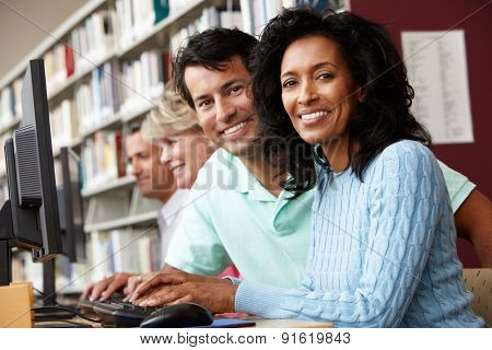 Students working on computers in library