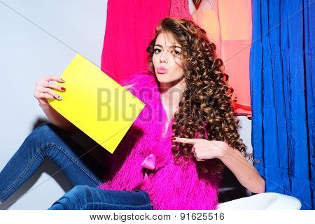 Attractive Lively Girl Sitting On Bathtub With Yellow Cardboard