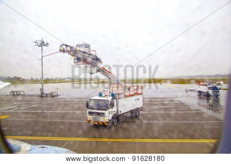 Deicing Truck Deices A Plane Before Take Off