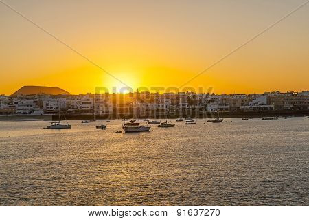 Sunset In The Harbor  With Sailing Boats
