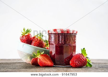 Strawberry Jam With Whole Fruits On Isalated Background And Wooden Table