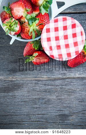 Strawberry Jam With Whole Fruits On Wooden Table