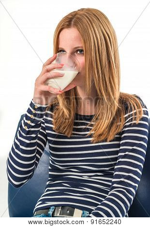 young woman drinking a glass of milk