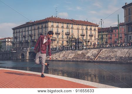 Handsome Asian Model Posing By An Artificial Basin