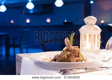 Grilled lamb on a dish. Dinner in restaurant.