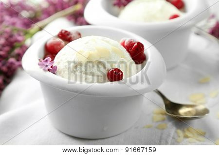 Beautiful composition with tasty ice cream and lilac flowers