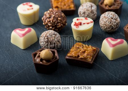 Selection Of Artisan Chocolates Praline On Black Background
